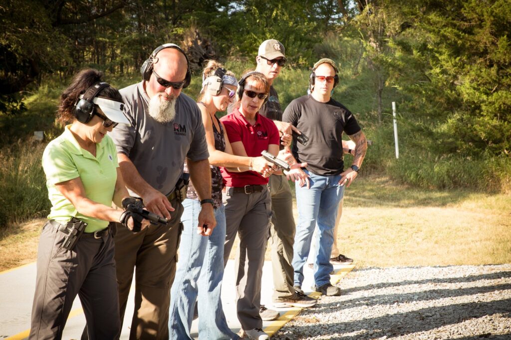 Ram Master Instructors give direction to a line of students all wearing ear and eye protection.